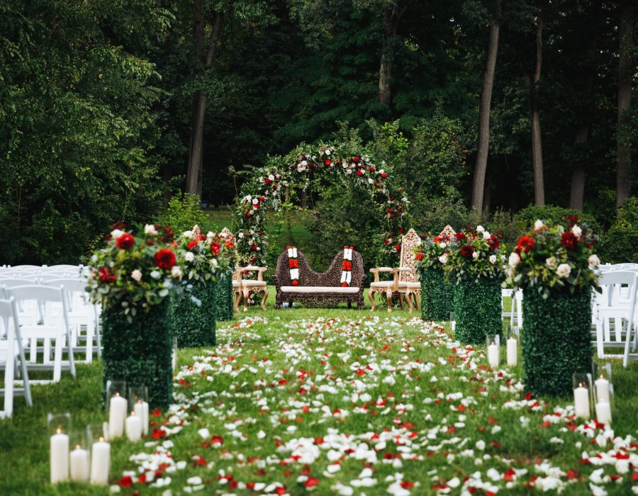 Rose petals cover green garden ready for traditional Hindu wedding ceremony